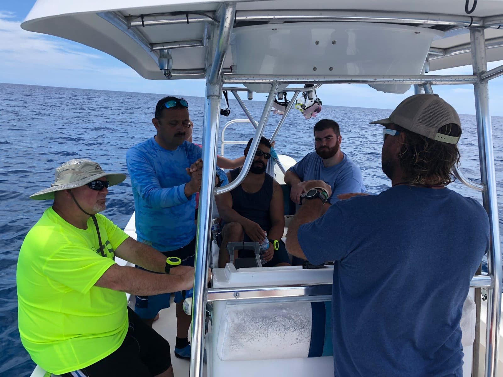 Team getting a dive briefing on the boat